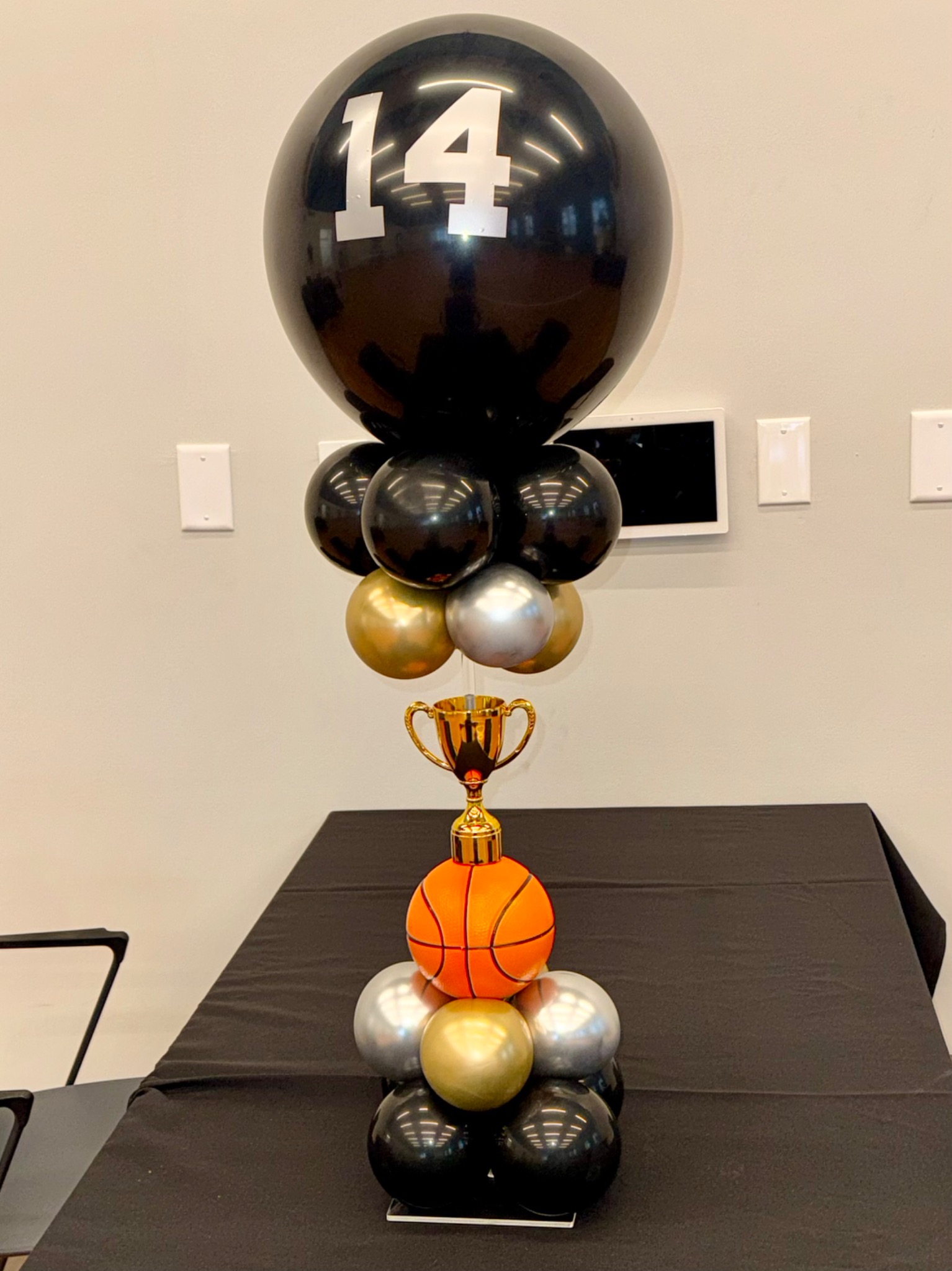 Black, gold, and silver basketball-themed fourteenth birthday centerpiece