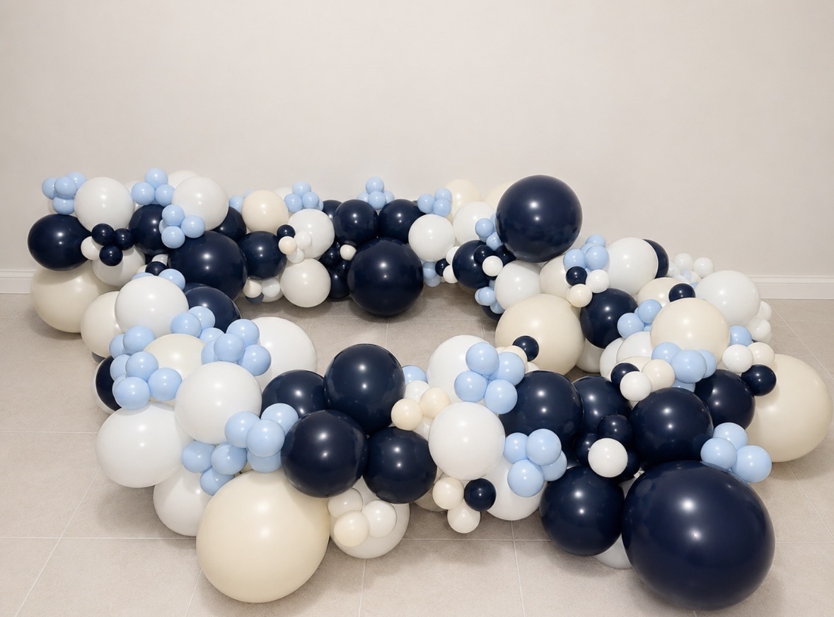 Wide view of a navy, powder blue, and white balloon garland