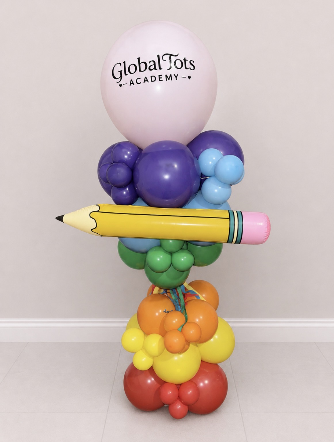 Colorful pencil-shaped balloon sculpture made for a school celebration